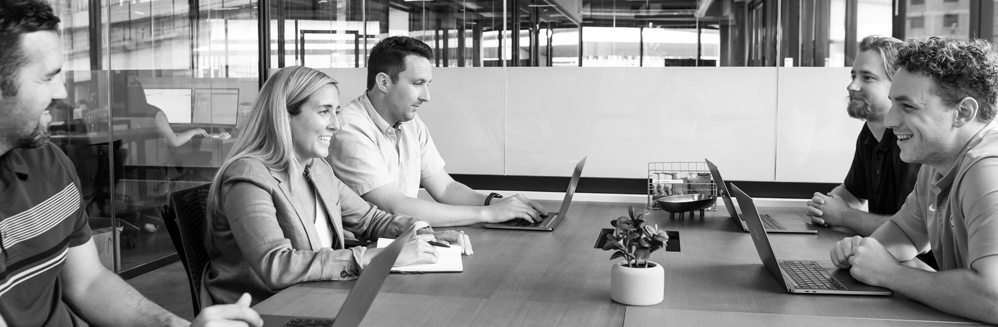 people-sitting-at-table-with-laptops